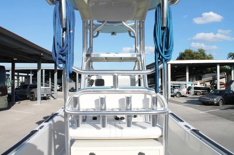 Slide: The Image of 2018 Andros 26 Tarpon boat with blue ropes and metal railings in a parking area. - 13
