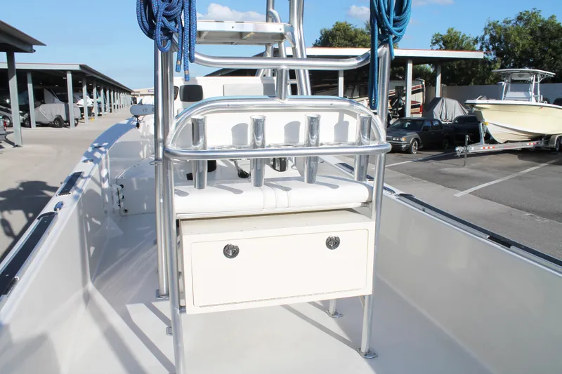Slide: The Image of 2018 Andros 26 Tarpon boat interior with seating and storage, docked under a clear sky. - 14