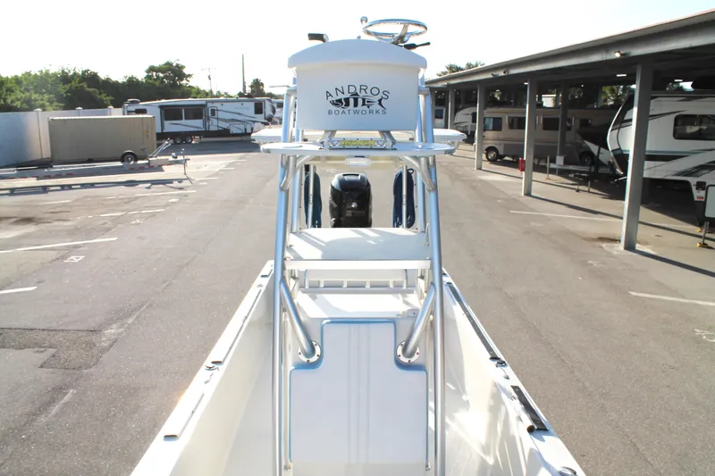 Slide: The Image of 2018 Andros 26 Tarpon boat in a parking area, showcasing its elevated helm station. - 26