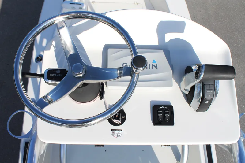 Slide: The Image of 2018 Andros 26 Tarpon boat console with steering wheel and Garmin display. - 28