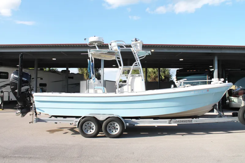 Slide: The Image of 2018 Andros 26 Tarpon boat on trailer, parked outdoors under a canopy. - 6
