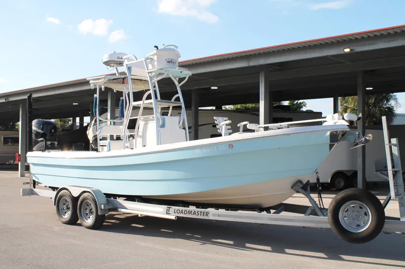 Slide: The Image of 2018 Andros 26 Tarpon boat on trailer, parked outdoors under a canopy. - 7