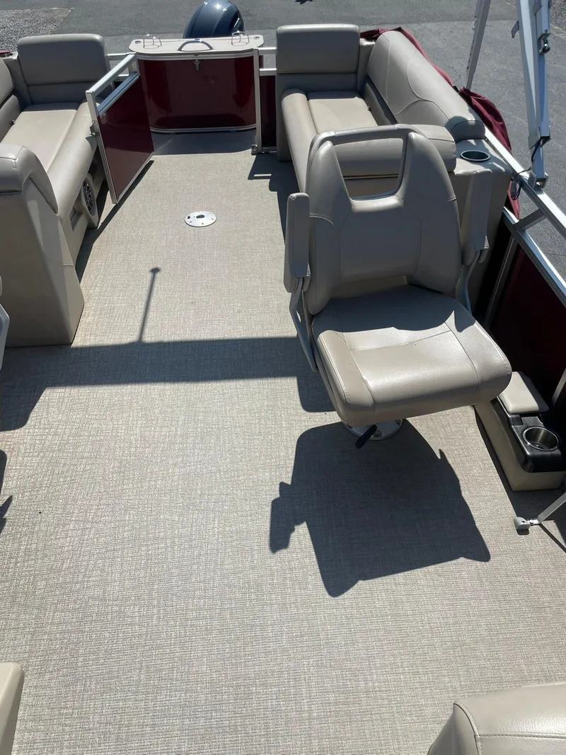 Slide: The Image of 2021 Avalon GS Quad Lounger boat interior with beige seating and spacious layout. - 12