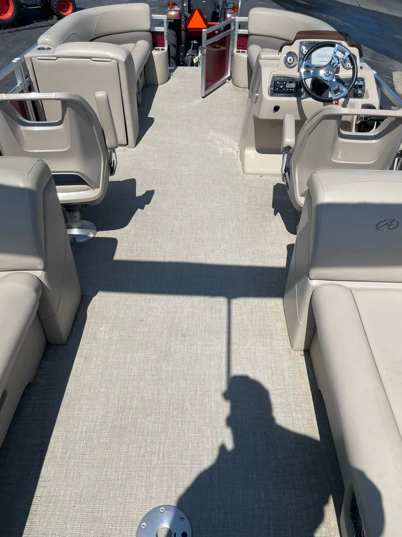 Slide: The Image of 2021 Avalon GS Quad Lounger boat interior with beige seating and steering console. - 16