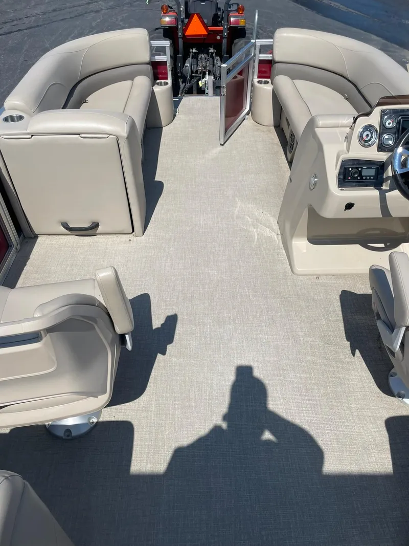 Slide: The Image of 2021 Avalon GS Quad Lounger boat interior with beige seating and steering console. - 21