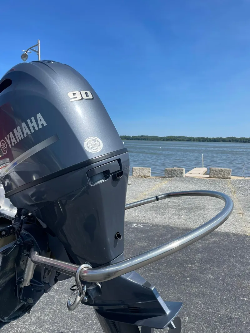 Slide: The Image of 2021 Avalon GS Quad Lounger with Yamaha 90 engine by a lakeside. - 4