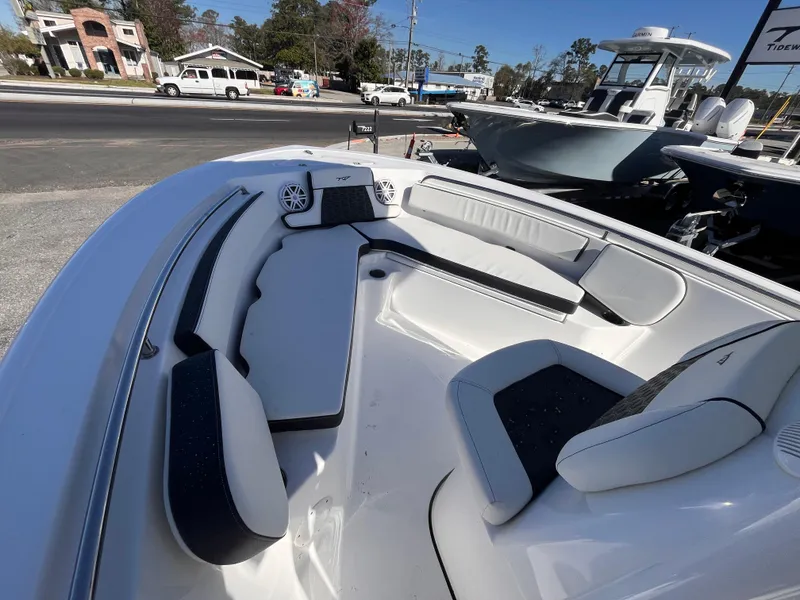 Slide: The Image of 2025 Tidewater 210 CC Adventure boat interior with cushioned seating and modern design. - 11