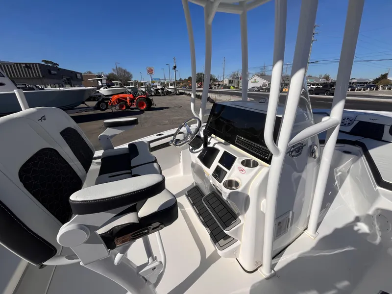 Slide: The Image of 2025 Tidewater 210 CC Adventure boat interior with modern console and seating. - 14