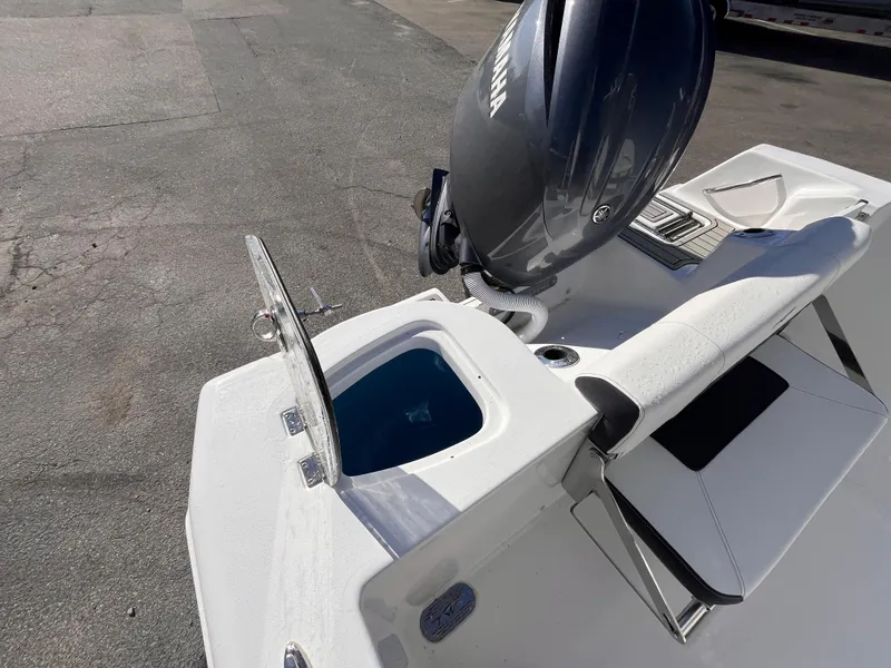 Slide: The Image of 2025 Tidewater 210 CC Adventure boat with Yamaha engine, featuring a livewell and seating area. - 16