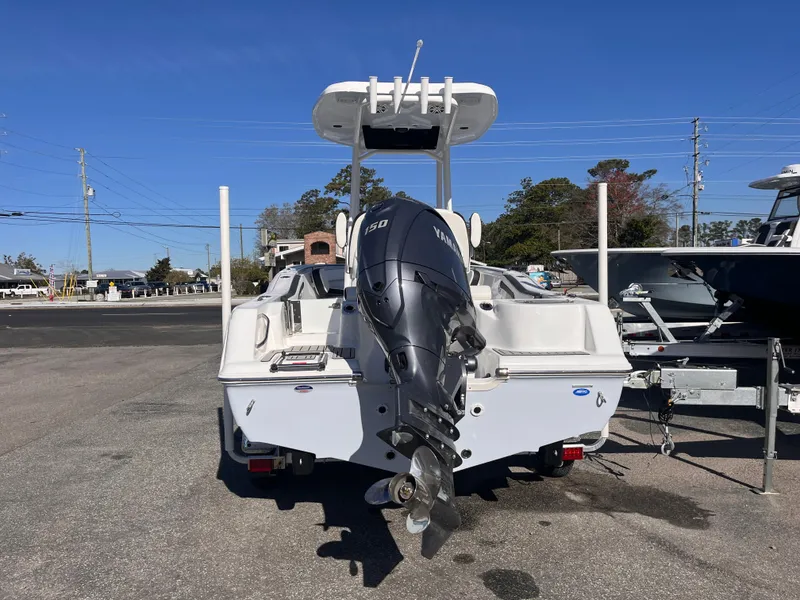 Slide: The Image of 2025 Tidewater 210 CC Adventure boat with Yamaha outboard motor, parked on a sunny day. - 3