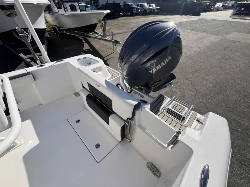 Slide: The Image of 2025 Tidewater 210 CC Adventure boat with Yamaha engine, docked in a marina. - 5