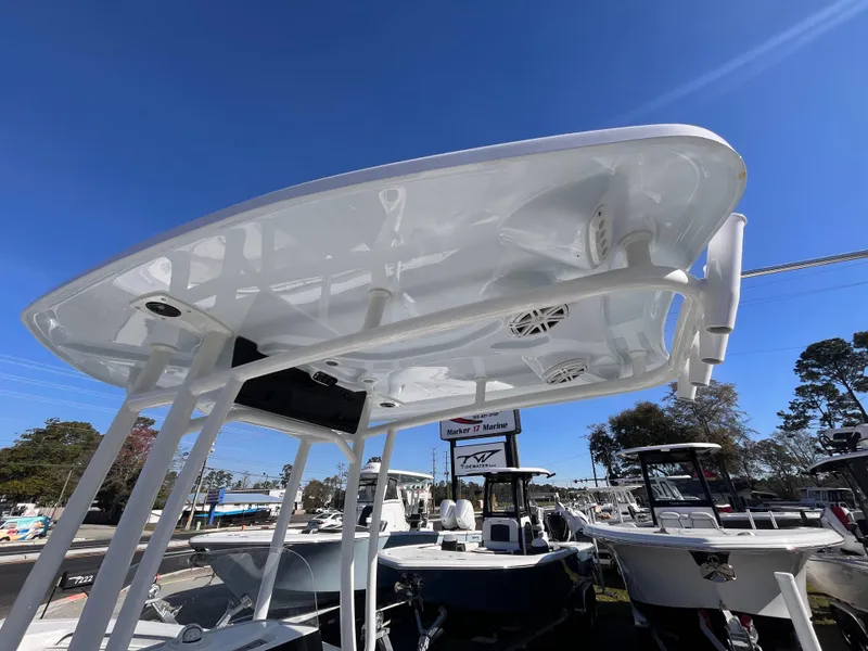 Slide: The Image of 2025 Tidewater 210 CC Adventure boat with T-top under clear blue sky. - 9