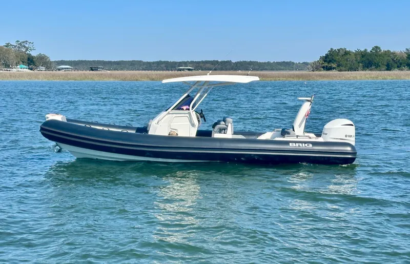 Slide: The Image of 2021 Brig Eagle 8 boat on calm water with clear blue sky. - 1