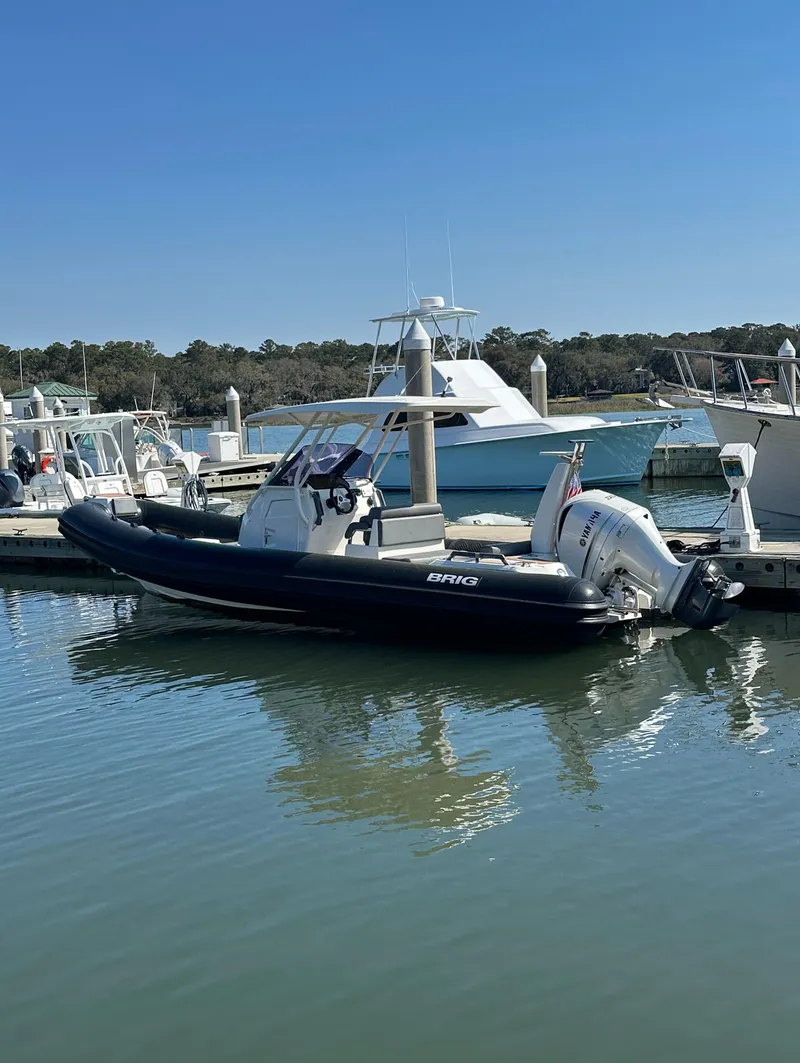 Slide: The Image of 2021 Brig Eagle 8 boat docked at marina under clear blue sky. - 13