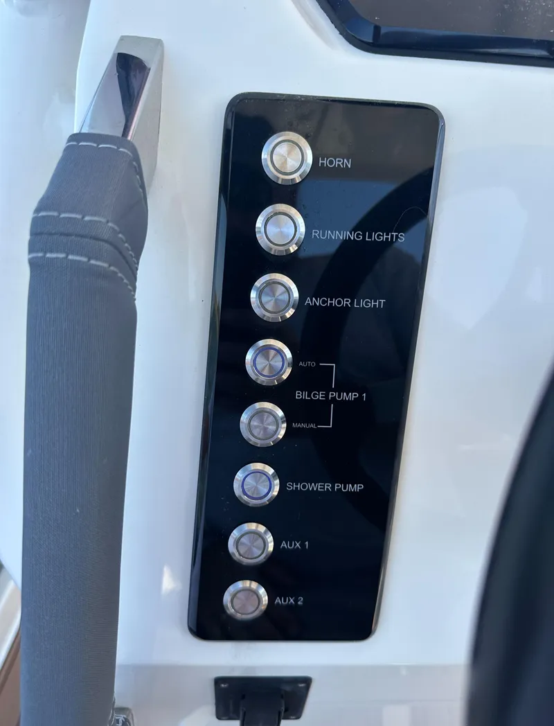 Slide: The Image of Control panel of 2021 Brig Eagle 8 boat with labeled switches. - 14