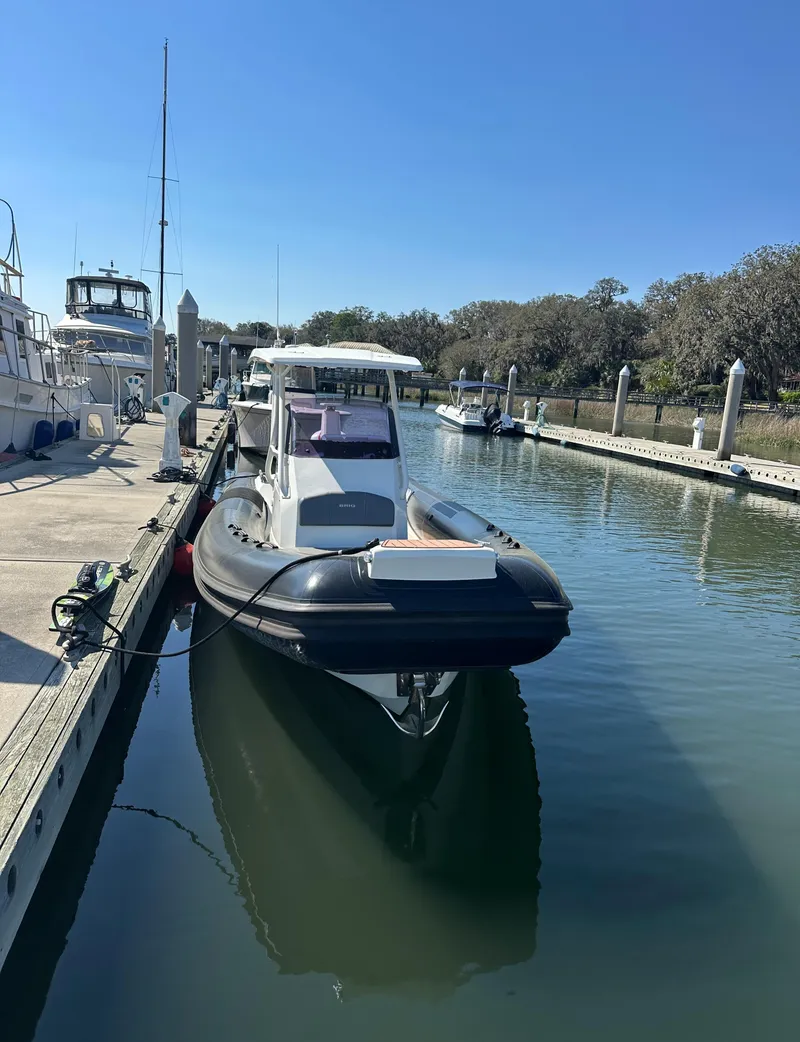 Slide: The Image of 2021 Brig Eagle 8 boat docked in a serene marina setting. - 15