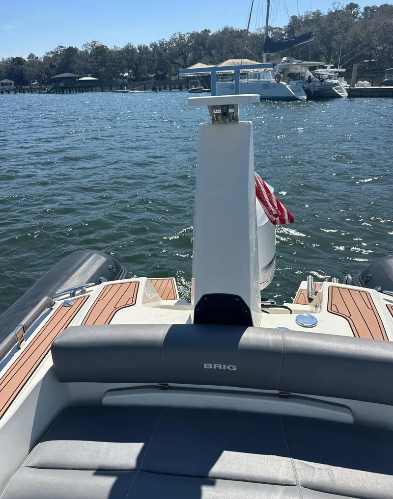 Slide: The Image of 2021 Brig Eagle 8 boat on water, featuring sleek seating and wooden deck accents. - 7