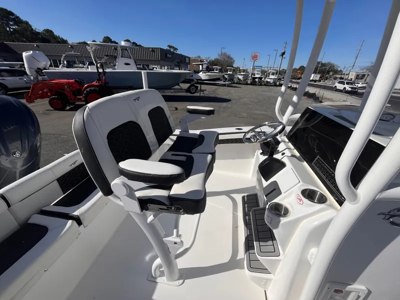 Slide: The Image of 2025 Tidewater 210 LXF boat interior with dual seats and steering console. - 14