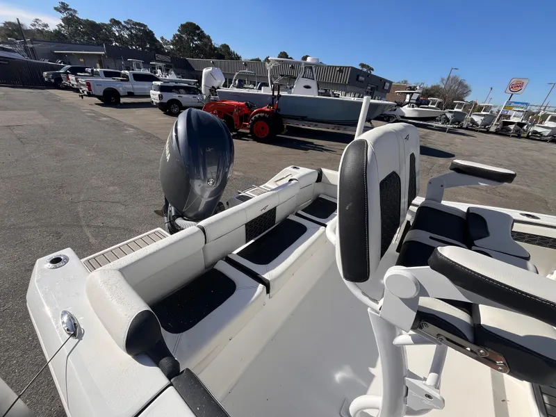 Slide: The Image of 2025 Tidewater 210 LXF boat with seating and motor, parked outdoors on a sunny day. - 15