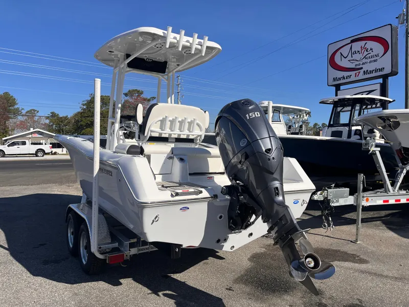 Slide: The Image of 2025 Tidewater 210 LXF boat with outboard motor on trailer at dealership. - 2