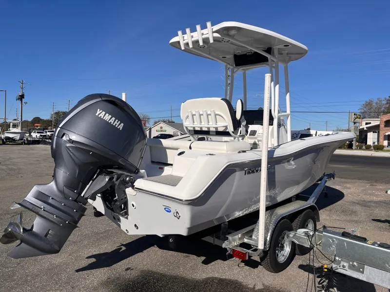 Slide: The Image of 2025 Tidewater 210 LXF boat with Yamaha engine on a trailer, parked outdoors. - 4