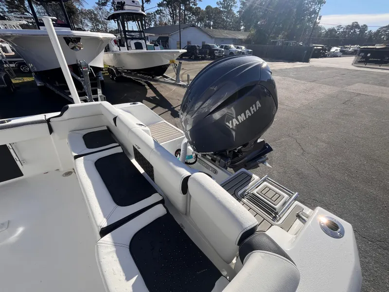 Slide: The Image of 2025 Tidewater 210 LXF boat with Yamaha engine, parked outdoors in a sunny setting. - 5