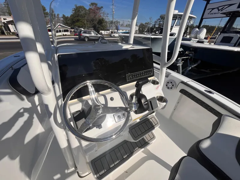 Slide: The Image of 2025 Tidewater 210 LXF boat console with steering wheel and controls. - 8