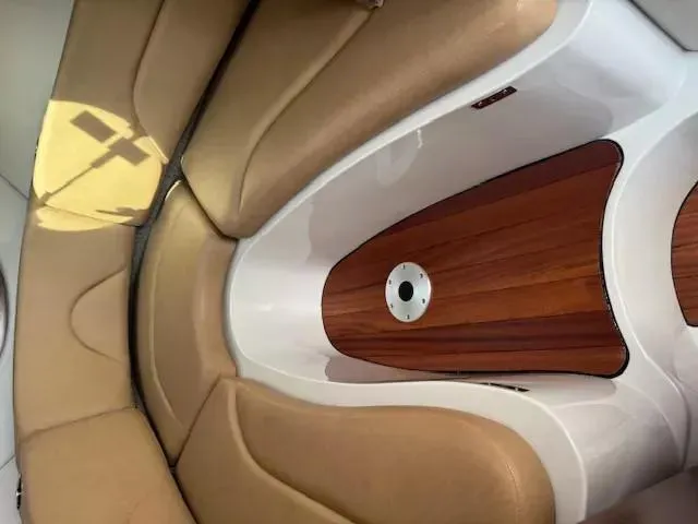 Slide: The Image of 2024 Crownline 270 CR boat interior with tan seating and wood accents. - 19