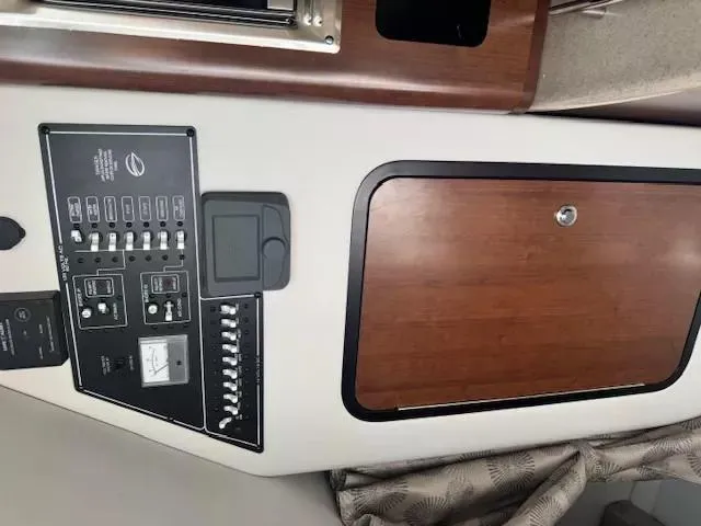 Slide: The Image of 2024 Crownline 270 CR control panel and wooden cabinet interior view. - 22