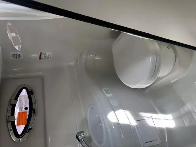 Slide: The Image of 2024 Crownline 270 CR boat bathroom interior with toilet and sink. - 25