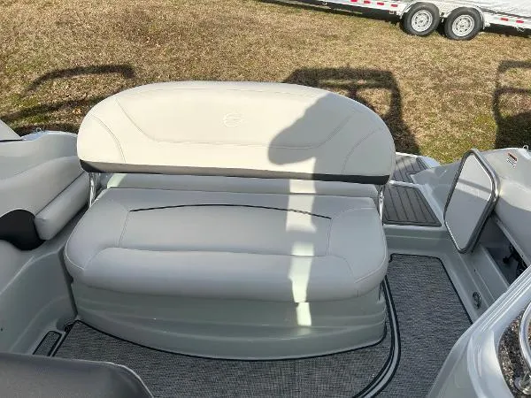 Slide: The Image of 2024 Crownline 270 CR boat interior with cushioned seating and carpeted flooring. - 7