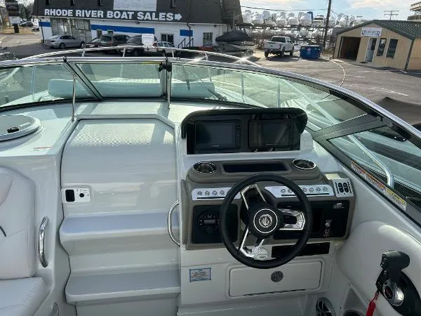 Slide: The Image of 2024 Crownline 270 CR boat dashboard with steering wheel and navigation screens. - 9
