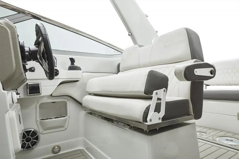 Slide: The Image of 2024 Crownline 280 CRX boat interior with white seating and steering wheel. - 11