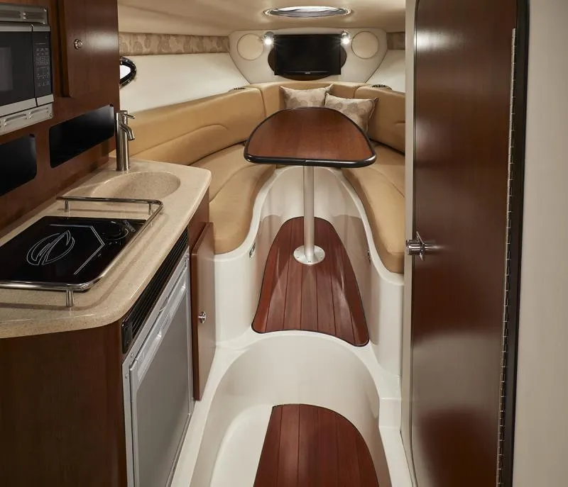 Slide: The Image of 2024 Crownline 280 CRX cabin interior with kitchenette and seating area. - 13