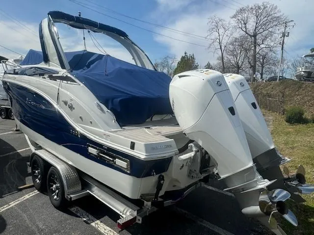 Slide: The Image of 2024 Crownline 280 CRX boat with dual outboard motors on a trailer. - 4