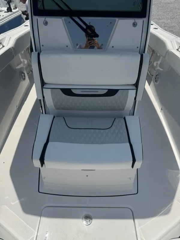 Slide: The Image of 2025 Blackfin 272 CC boat interior with cushioned seating and modern design. - 10