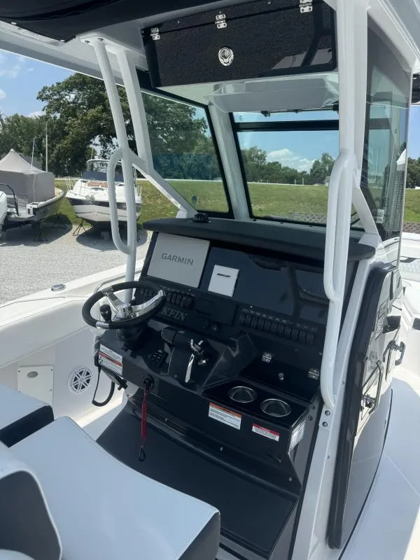 Slide: The Image of 2025 Blackfin 272 CC boat cockpit with Garmin navigation system and steering wheel. - 16
