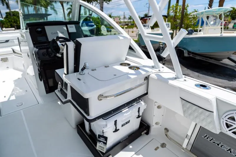 Slide: The Image of 2025 Blackfin 252 DC boat interior with Yeti cooler and Garmin navigation system. - 11