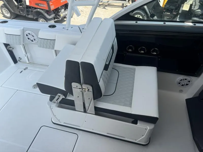 Slide: The Image of 2025 Blackfin 252 DC boat interior with white seating and modern design. - 13