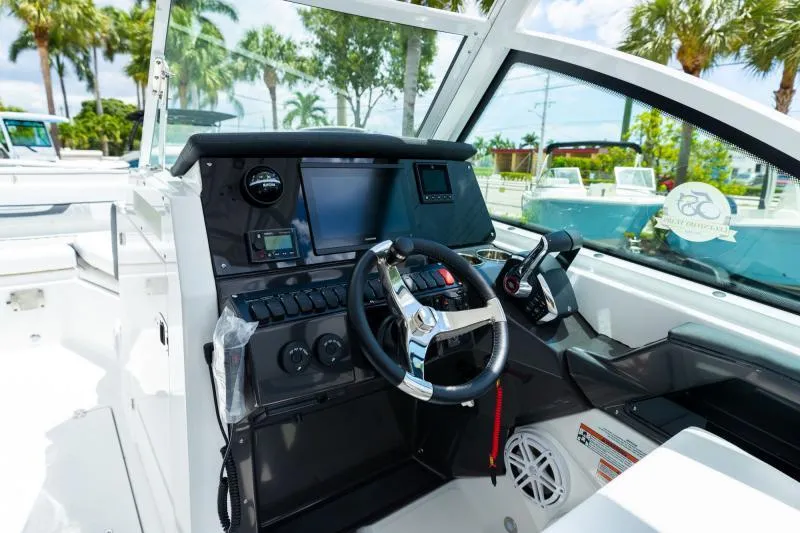 Slide: The Image of 2025 Blackfin 252 DC boat cockpit with modern steering and control panel. - 15