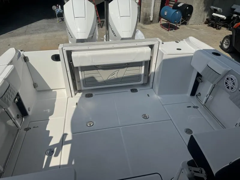 Slide: The Image of 2025 Blackfin 252 DC boat deck with dual outboard motors, spacious seating, and storage compartments. - 7