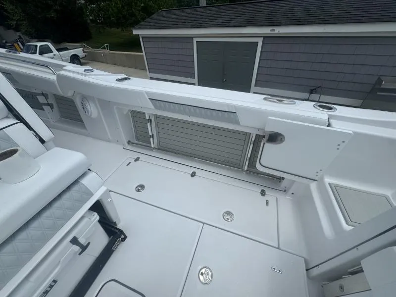 Slide: The Image of 2025 Blackfin 302 CC boat deck with storage compartments and seating. - 11
