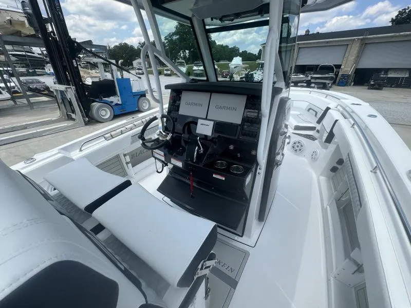 Slide: The Image of 2025 Blackfin 302 CC boat cockpit with Garmin navigation displays and seating. - 12