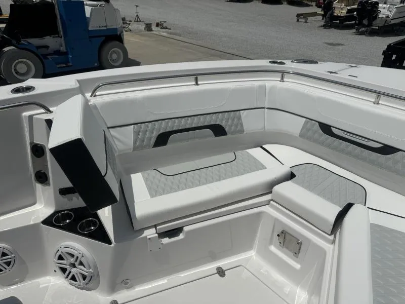 Slide: The Image of 2025 Blackfin 302 CC boat interior with white cushioned seating and cup holders. - 16