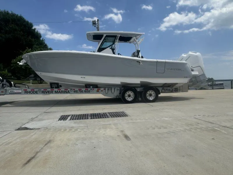Slide: The Image of 2025 Blackfin 302 CC boat on trailer at Rhode River Marina under blue sky. - 3