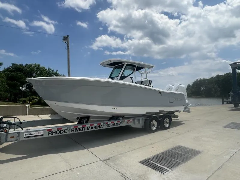 Slide: The Image of 2025 Blackfin 302 CC boat on trailer at Rhode River Marina under cloudy sky. - 4