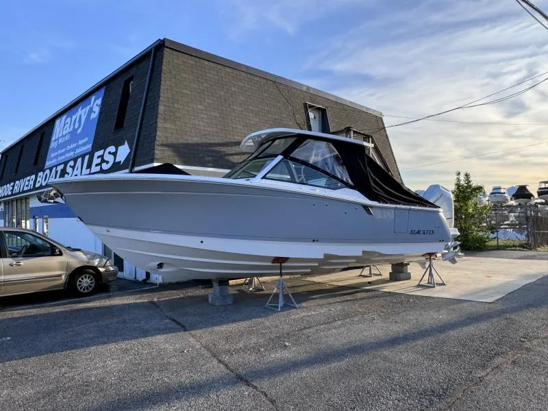 Slide: The Image of 2025 Blackfin 302 DC boat displayed at a boat sales lot. - 1