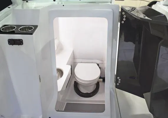 Slide: The Image of 2025 Blackfin 302 DC boat interior with compact marine toilet and sink. - 13