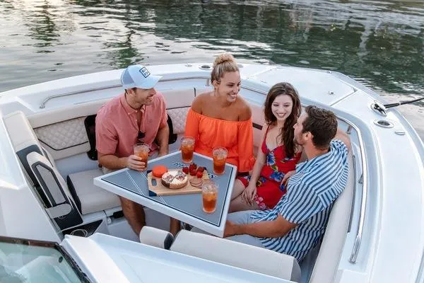 Slide: The Image of Group enjoying drinks on a 2025 Blackfin 302 DC boat. - 15
