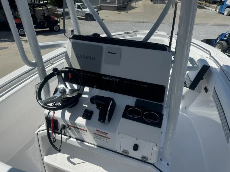 Slide: The Image of 2025 Blackfin 222 CC boat console with Garmin navigation and steering wheel. - 12